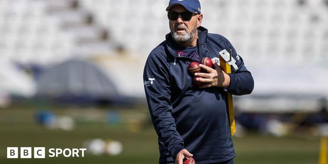 Darren Lehmann prepares to catch a cricket ball while wearing a baseball mitt