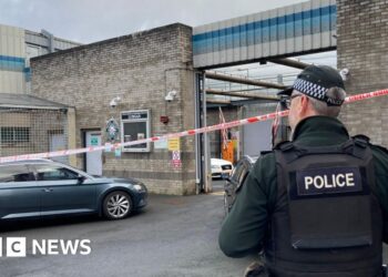 Delivery driver threatened at gunpoint in attack on police station