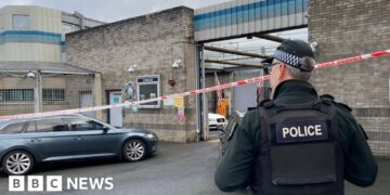 Delivery driver threatened at gunpoint in attack on police station