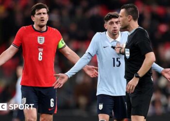 Harry Maguire of England and Federico Valverde of Uruguay react towards referee Sven Jablonski