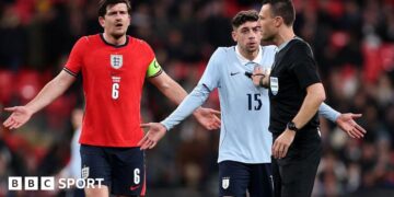 Harry Maguire of England and Federico Valverde of Uruguay react towards referee Sven Jablonski