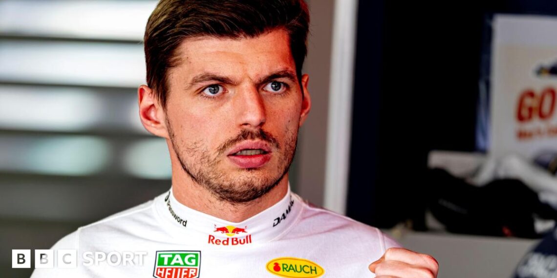 Max Verstappen wearing a white fireproof top in the Red Bull garage at the Japanese Grand Prix
