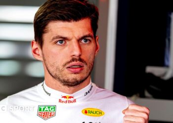 Max Verstappen wearing a white fireproof top in the Red Bull garage at the Japanese Grand Prix