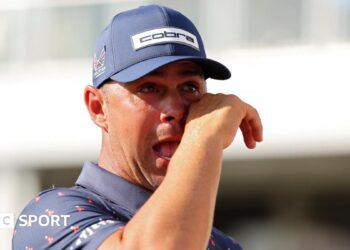 American golfer Gary Woodland cries as he embraces his wife Gabby after winning the Houston Open