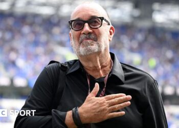 Designer Dan Meis applauds Everton fans at their first home match in their new stadium.