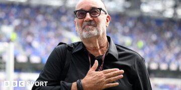Designer Dan Meis applauds Everton fans at their first home match in their new stadium.