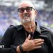 Designer Dan Meis applauds Everton fans at their first home match in their new stadium.