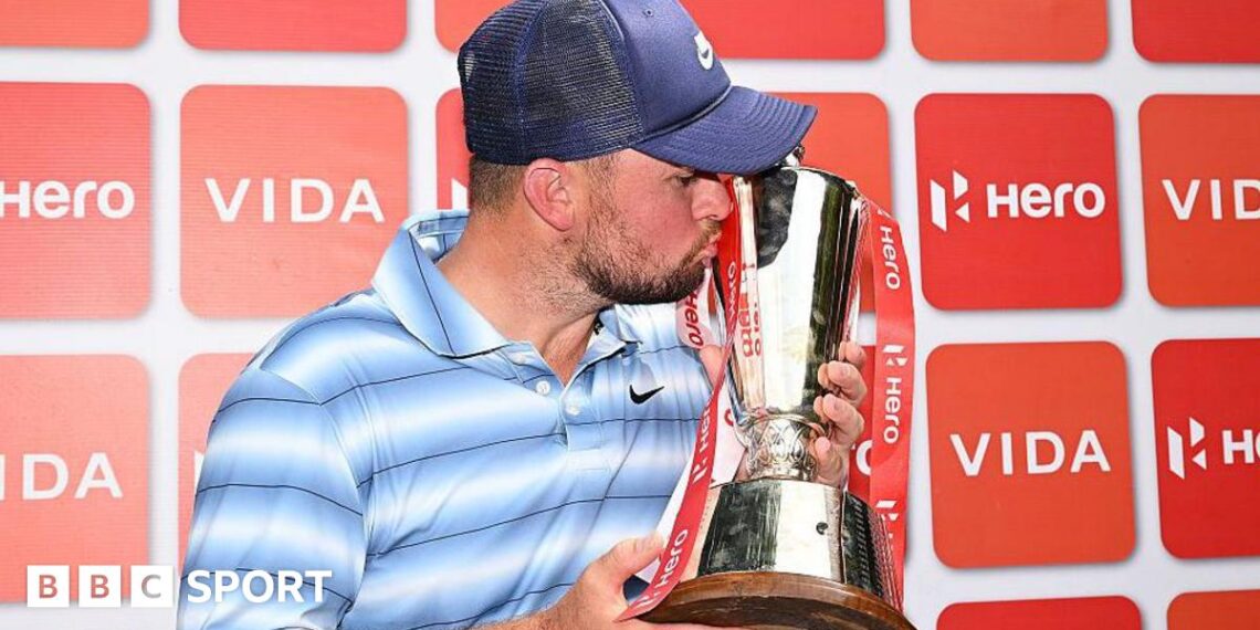 Alex Fitzpatrick kisses the Indian Open trophy
