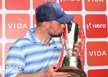 Alex Fitzpatrick kisses the Indian Open trophy