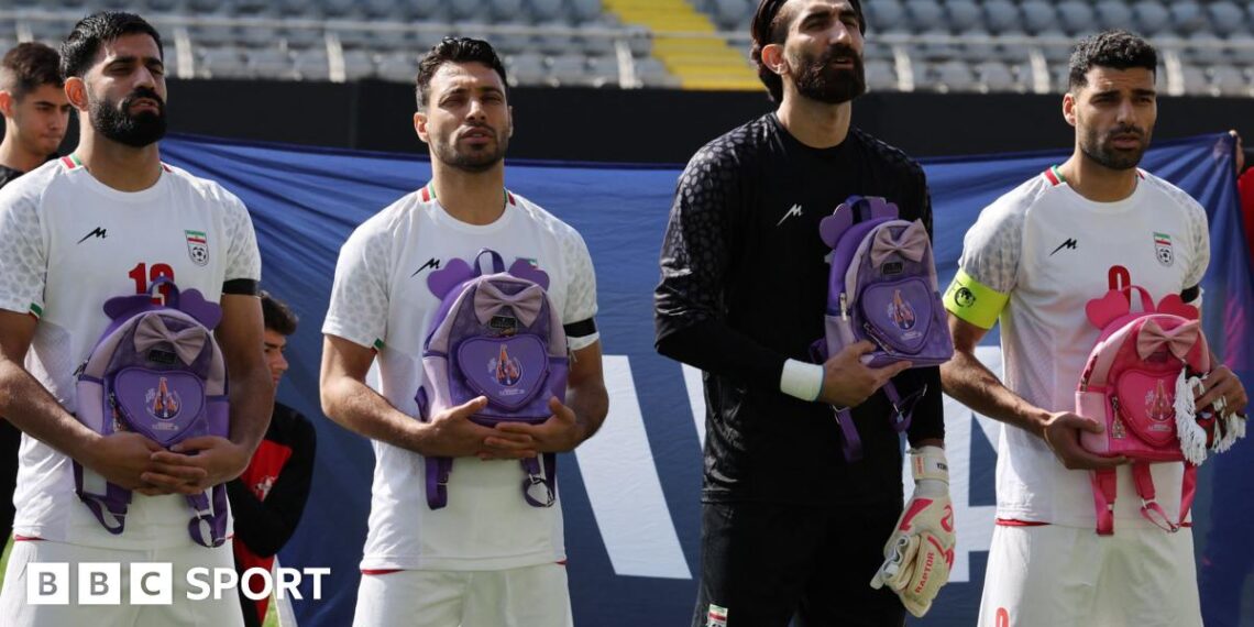 Iran's Hossein Kanaani, Shoja Khalilzadeh, Alireza Beiranvand and Mehdi Taremi hold school bags in memory of the victims of the girls school bombing in Minab, Iran