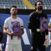 Iran's Hossein Kanaani, Shoja Khalilzadeh, Alireza Beiranvand and Mehdi Taremi hold school bags in memory of the victims of the girls school bombing in Minab, Iran
