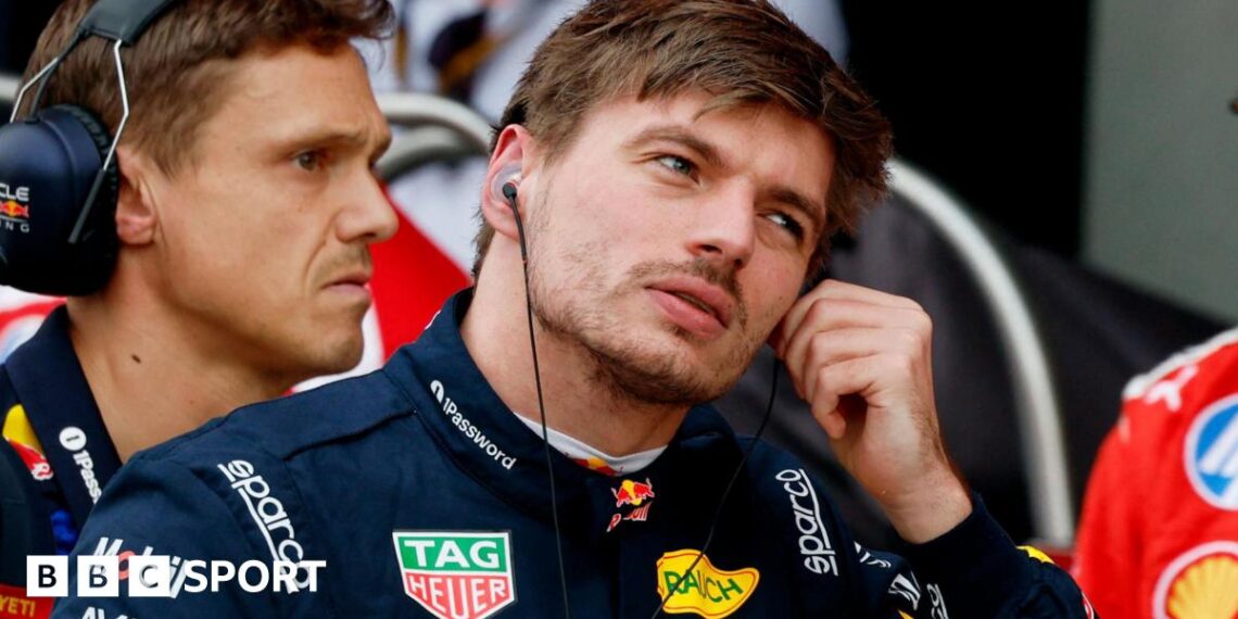 Max Verstappen removes his ear protectors after getting out of his Red Bull following qualifying for the Japanese Grand Prix