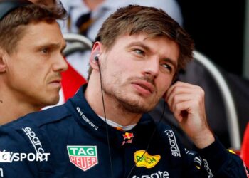 Max Verstappen removes his ear protectors after getting out of his Red Bull following qualifying for the Japanese Grand Prix