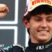 Kimi Antonelli smiles and clenches his fist in celebration on the podium after winning the Japanese Grand Prix