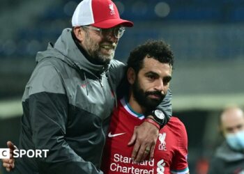 Liverpool boss Jurgen Klopp (left) embraces Mohamed Salah (right) after a Chamoions League match