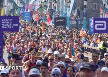 Thousands of runners pass across Tower Bridge during the London Marathon 2025