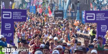 Thousands of runners pass across Tower Bridge during the London Marathon 2025