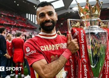 Mohamed Salah poses with the Premier League trophy