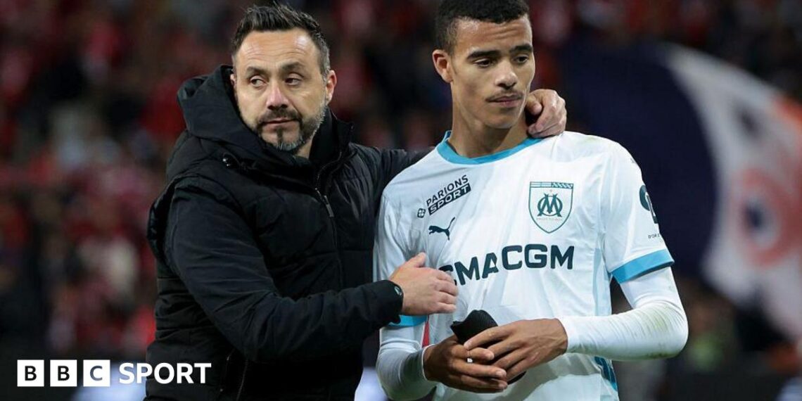 Roberto De Zerbi talks to Mason Greenwood following a Ligue 1 football match between Lille and Marseille