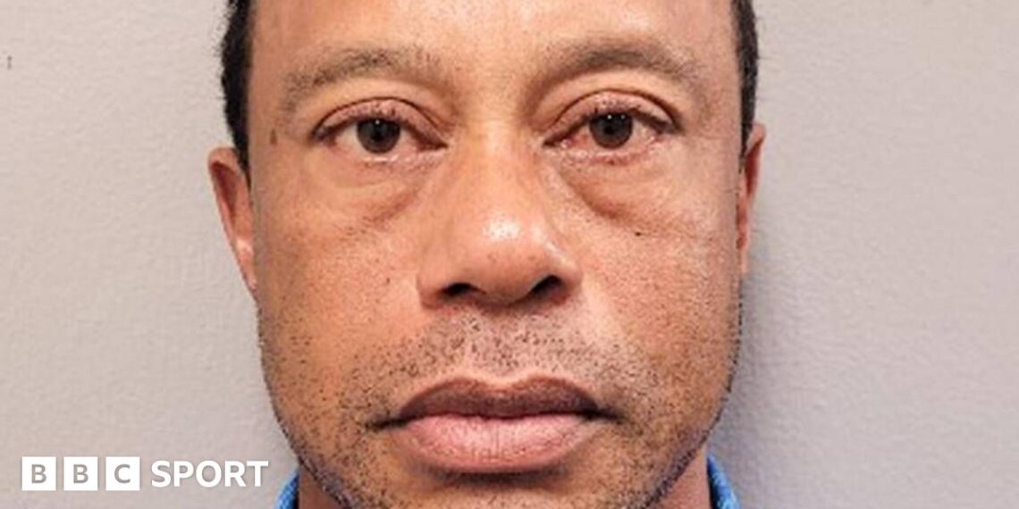 Tiger Woods in a red shirt and white cap