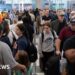 US airport mania: Travelers face hours-long wait times