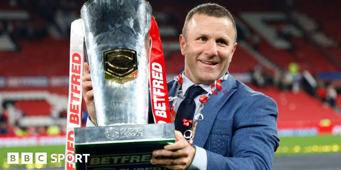 Hull KR coach Willie Peters holds the Super League trophy