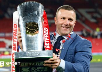 Hull KR coach Willie Peters holds the Super League trophy