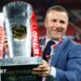 Hull KR coach Willie Peters holds the Super League trophy