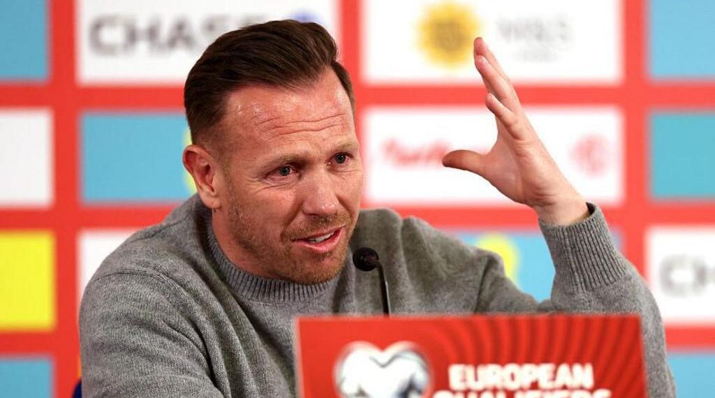 Craig Bellamy raises a hand during his post-match press conference