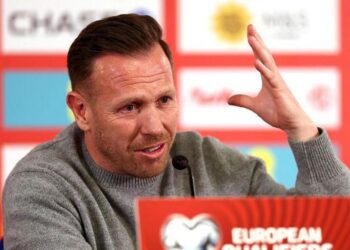 Craig Bellamy raises a hand during his post-match press conference