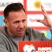 Craig Bellamy raises a hand during his post-match press conference