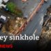 Huge sinkhole in Surrey swallows up more of street | BBC News