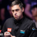 Ronnie O'Sullivan chalking his cue