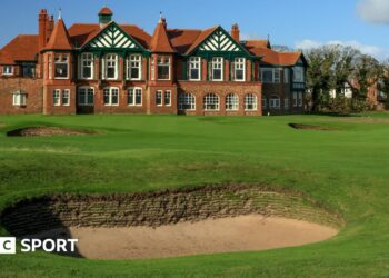 A view of a bunker in front of the 18th green at Royal Lytham & St Annes, with the clubhouse in the background