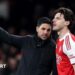 Mikel Arteta speaks to Declan Rice during a match