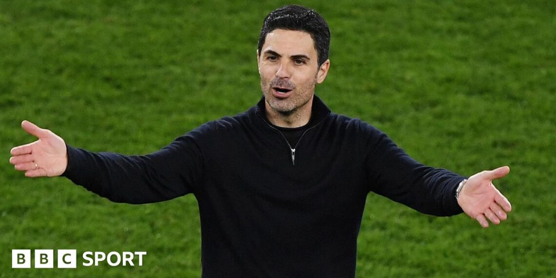 Mikel Arteta with his arms outstretched