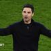 Mikel Arteta with his arms outstretched