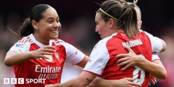 Olivia Smith nicks ball away from Lyon goalkeeper Christiane Endler