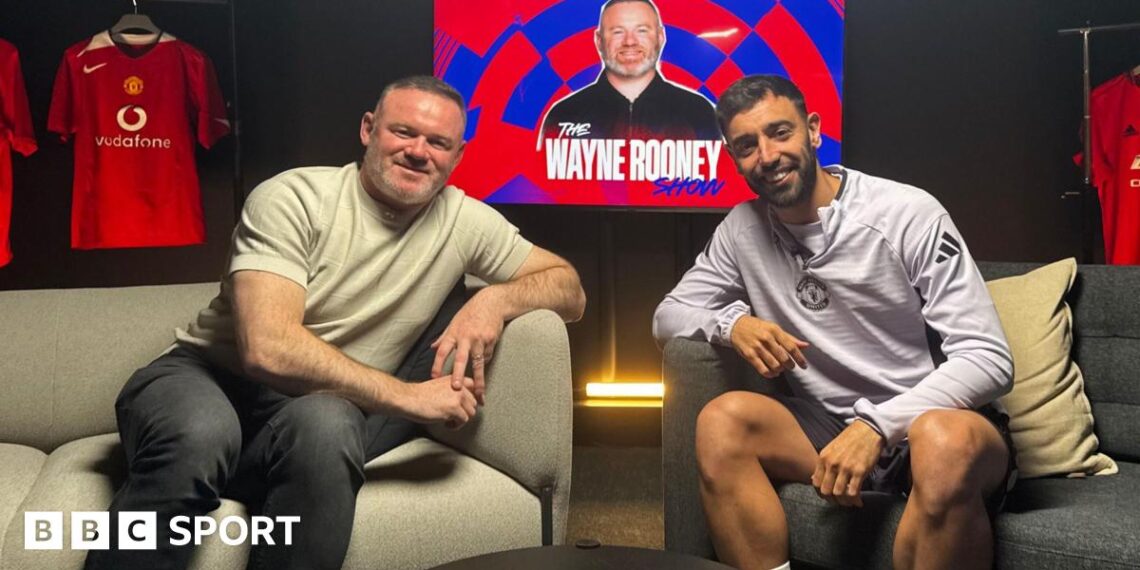 Wayne Rooney and Bruno Fernandes battle for the ball