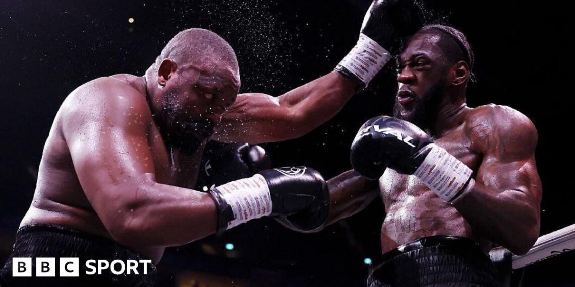 Derek Chisora is punched by Deontay Wilder