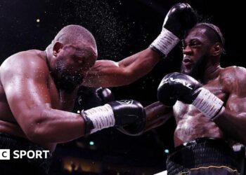 Derek Chisora is punched by Deontay Wilder