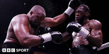 Derek Chisora is punched by Deontay Wilder