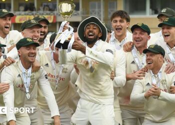 Haseeb Hameed lifts the County Championship trophy at Trent Bridge