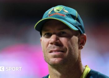 David Warner wearing an Australia cap