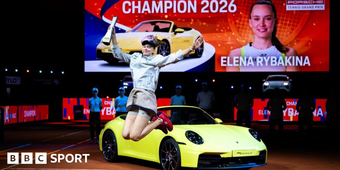 Elena Rybakina celebrates her victory in Stuttgart in front of the sports car that forms part of her winner's prize