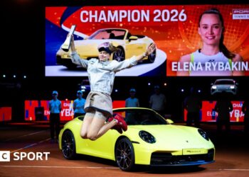 Elena Rybakina celebrates her victory in Stuttgart in front of the sports car that forms part of her winner's prize