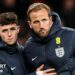 Phil Foden and Harry Kane in England blue coats after the defeat by Japan, with both players stern-faced