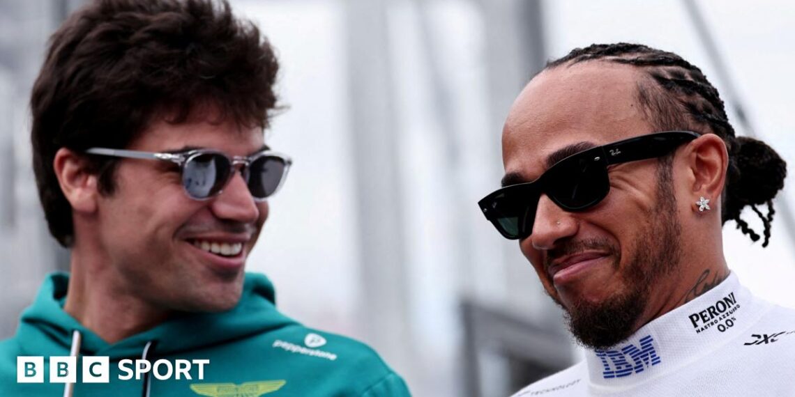Aston Martin driver Lance Stroll and Ferrari driver Lewis Hamilton smiling while in conversation at the 2026 Australian Grand Prix. Both men are wearing sunglasses