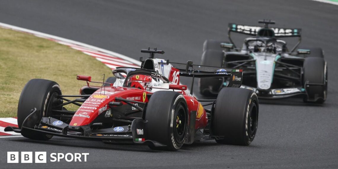 Ferrari's Charles Leclerc goes around a right-hand corner during the Japanese Grand Prix with Mercedes' George Russell right behind him
