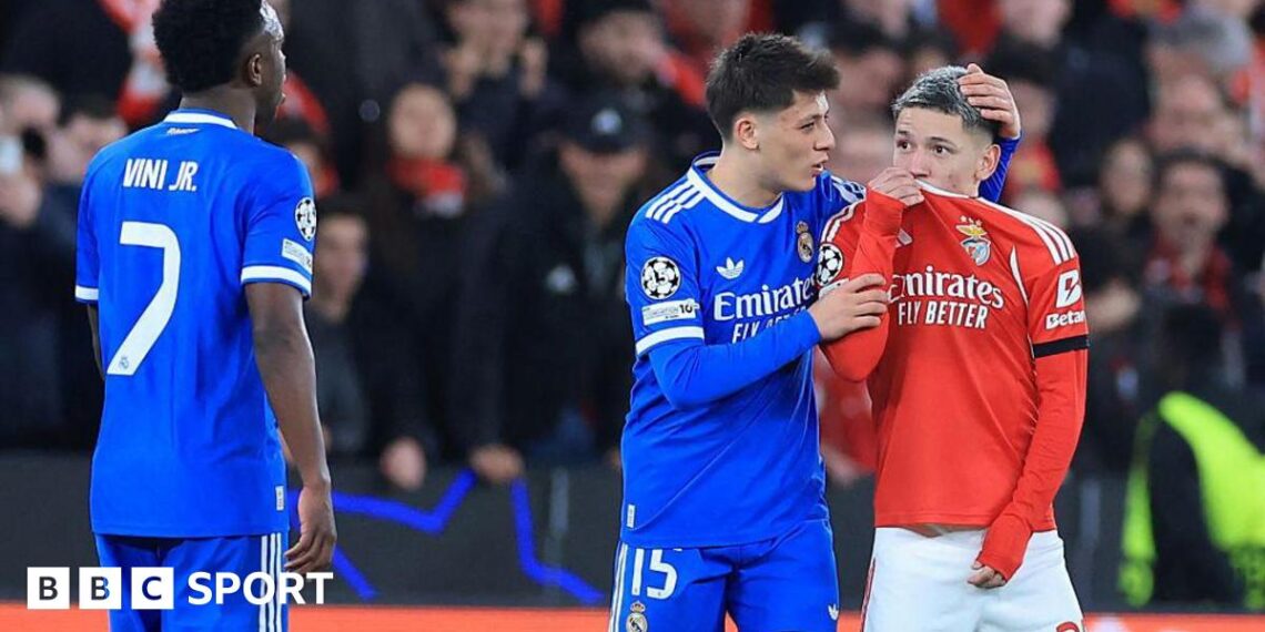 SL Benfica's Argentine forward Gianluca Prestianni hides his mouth while arguing with Real Madrid's Brazilian forward Vinicius Junior